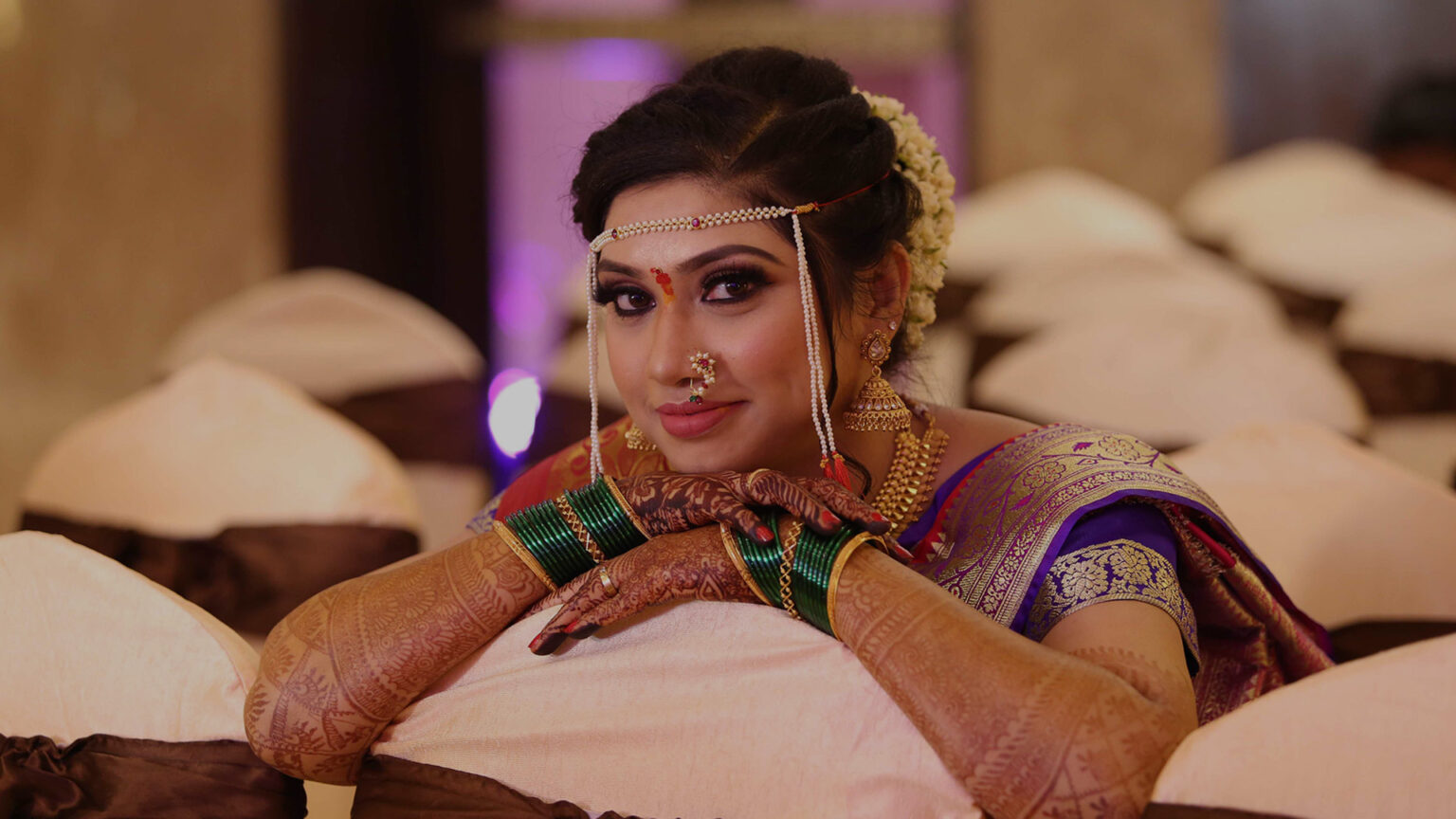 Bridal makeup artist applying makeup to a bride, showcasing professional skills and attention to detail for a flawless wedding look.



